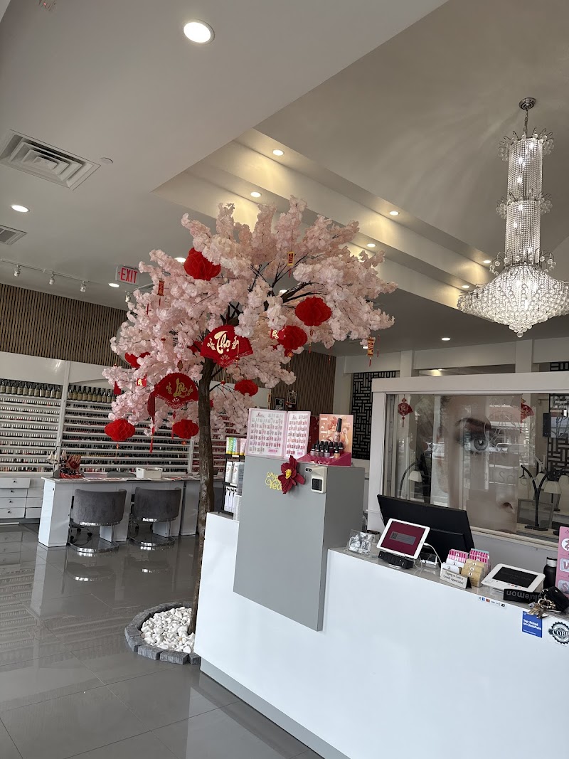 Inside Parisian Nail Salon — crystal chandelier, cherry blossom tree, elegant decor