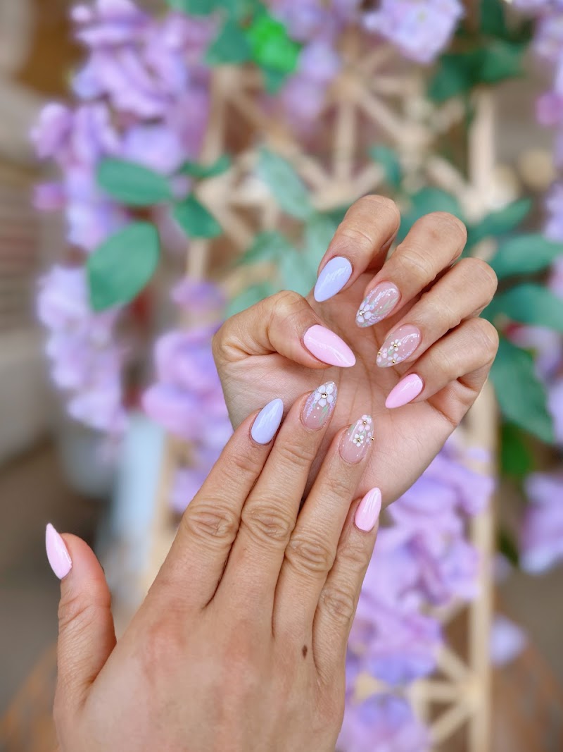 Pastel nail art with floral backdrop